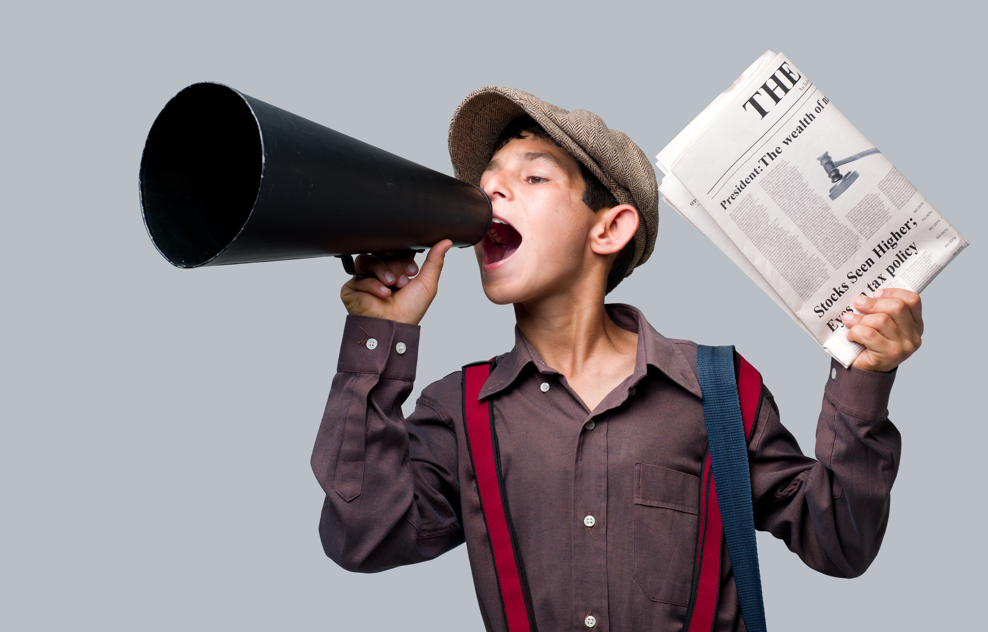 Newsboy holding newspaper and shouting to sell
